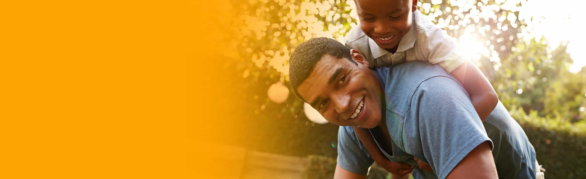 a father and son play in a park