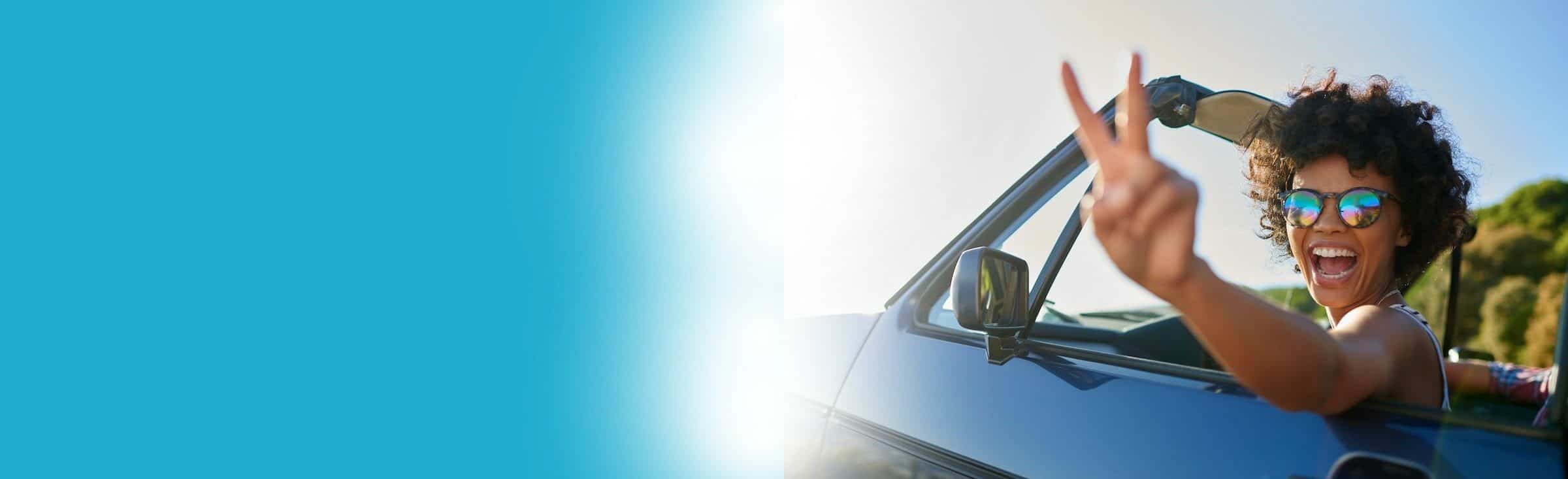 woman in car with peace sign